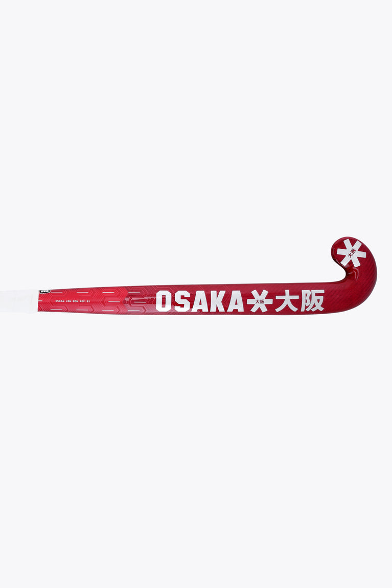 Hot pink field hockey stick blade with printed OSAKA branding and star icon