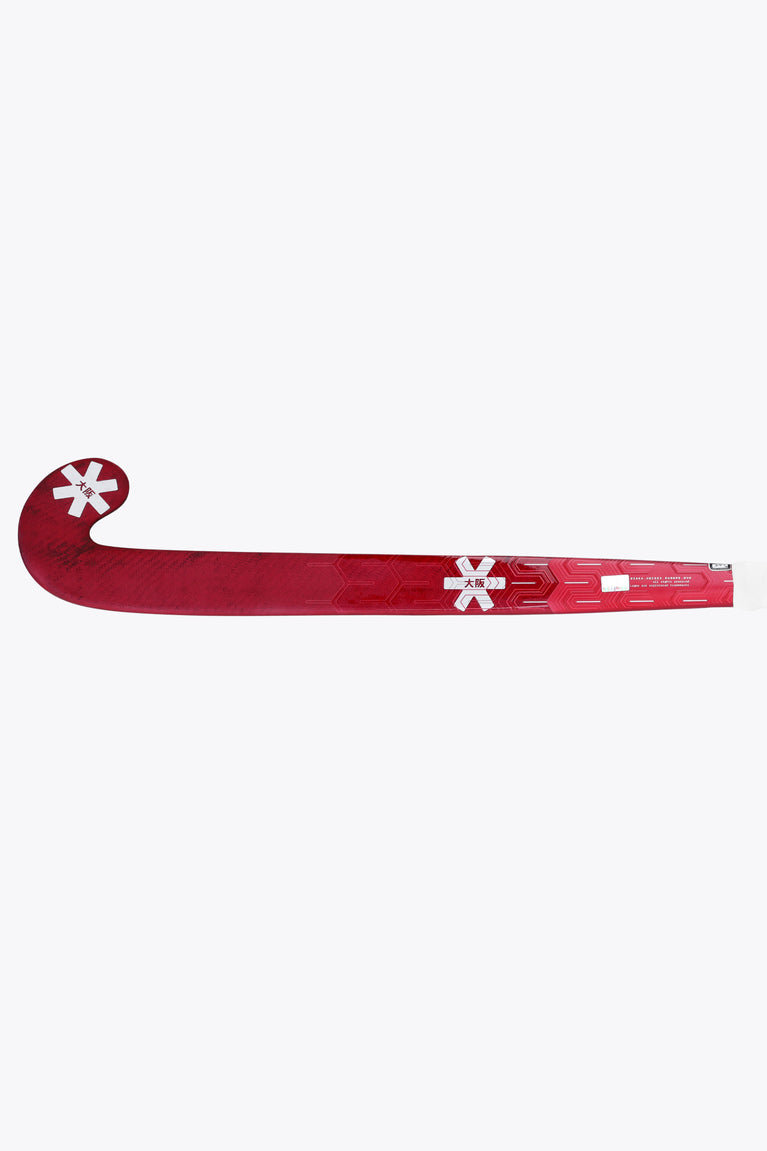 Hot pink field hockey stick with curved blade and printed markings along the shaft