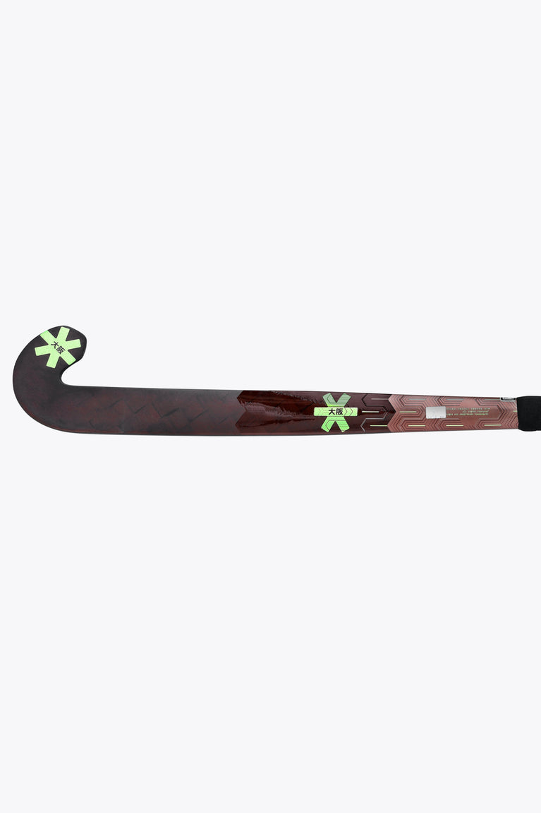 Field hockey stick blade side view, dark brown surface with green star details