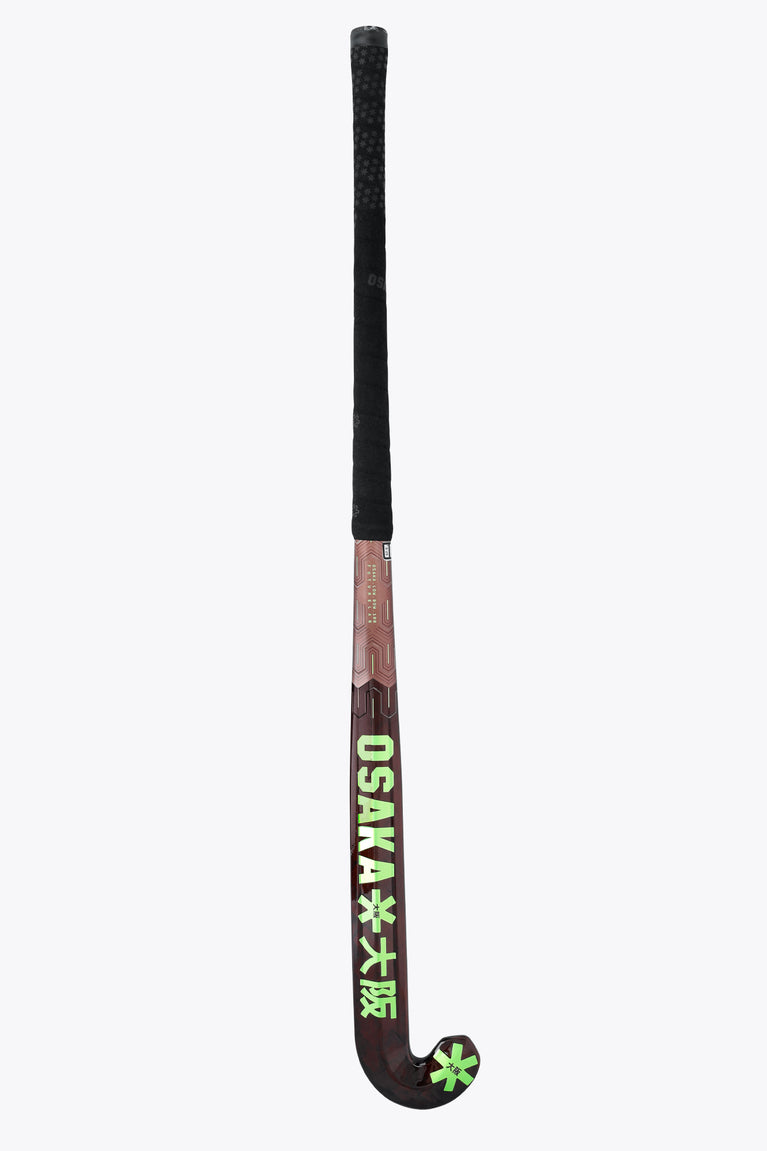 Field hockey stick with OSAKA text on shaft and green star on curved blade, black grip
