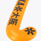 Orange field hockey stick head close-up with Osaka print and dark star marks