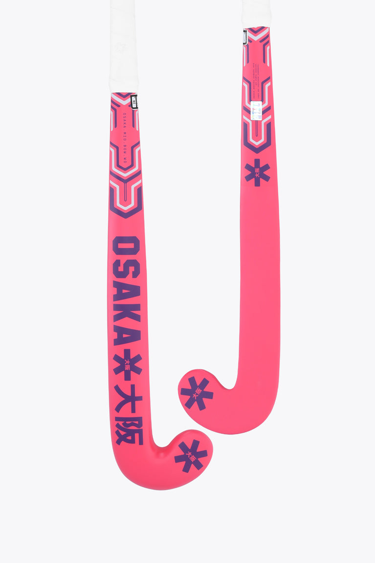 Hot pink mid-bow field hockey stick with patterned grip at the handle
