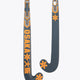 Field hockey stick head, dark gray with orange accent graphic on curved blade