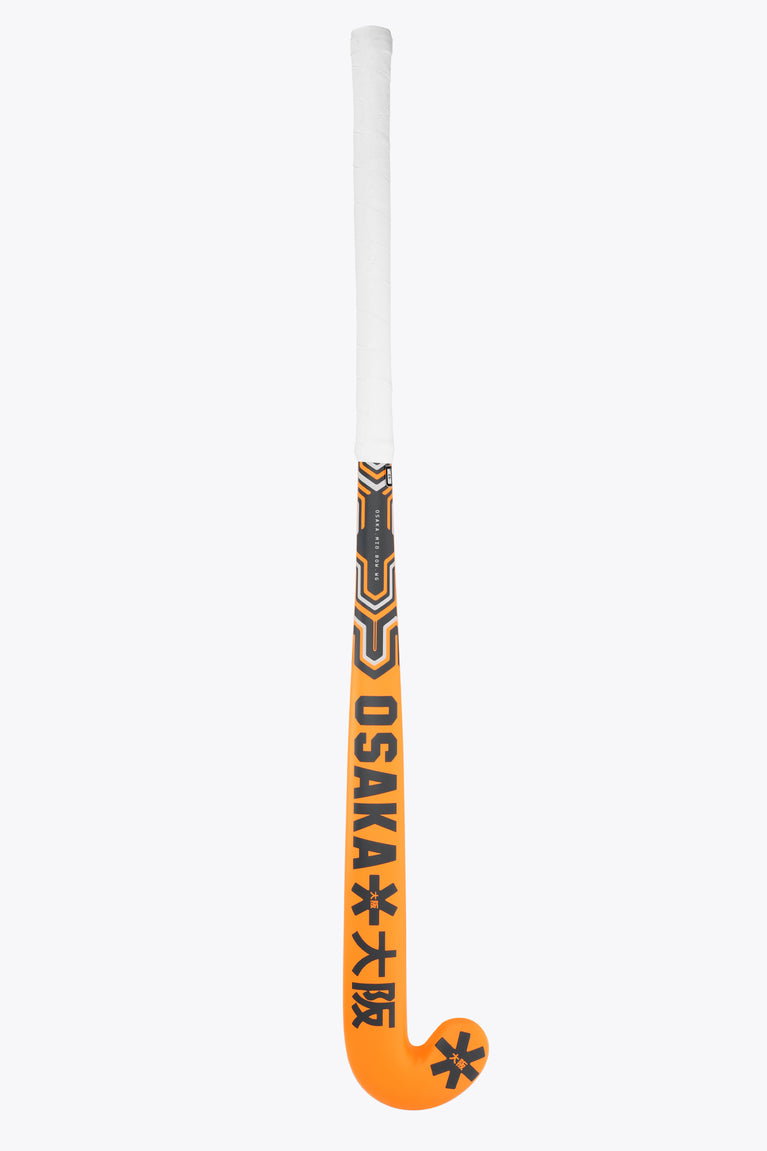 Orange field hockey stick with Osaka lettering on black-and-gold patterned section