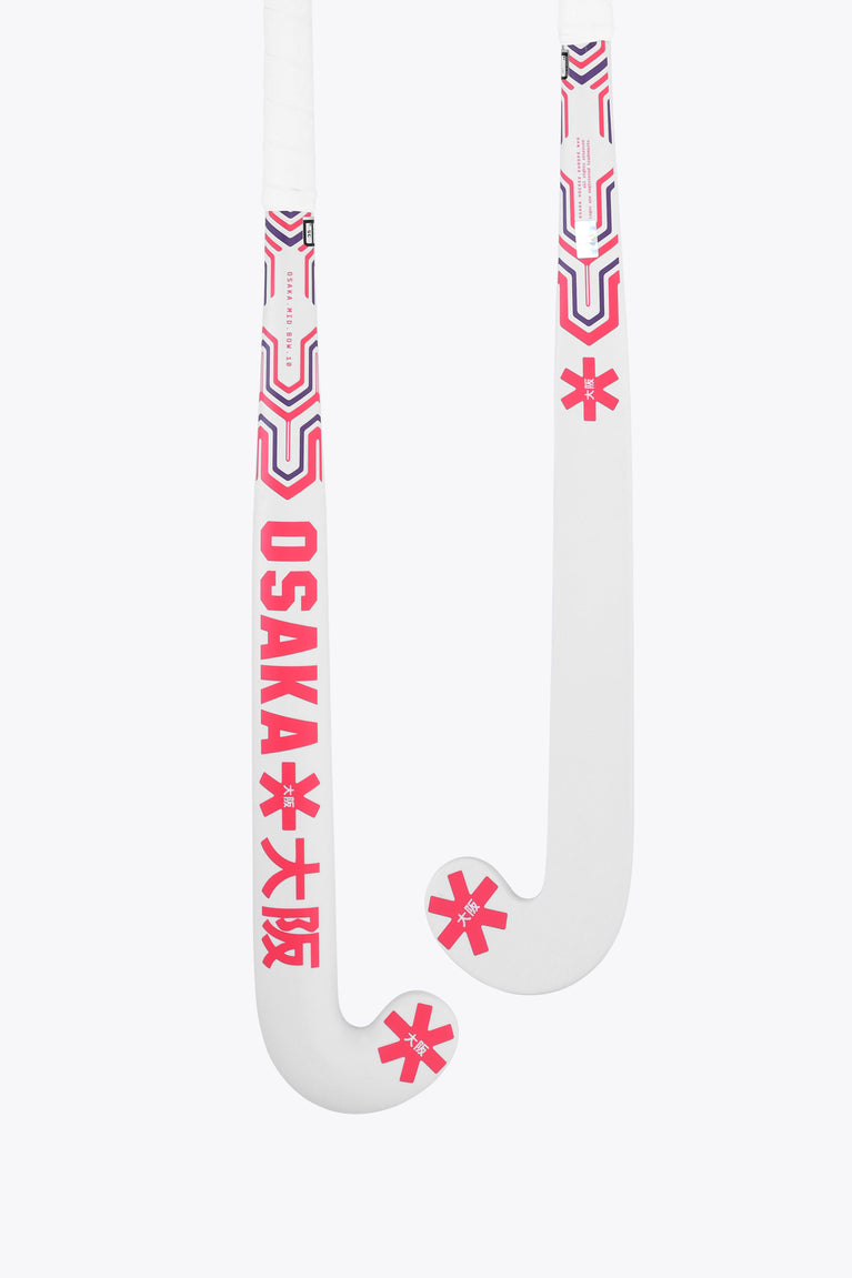White field hockey stick with hot pink and blue grip decals, showing mid-bow curve