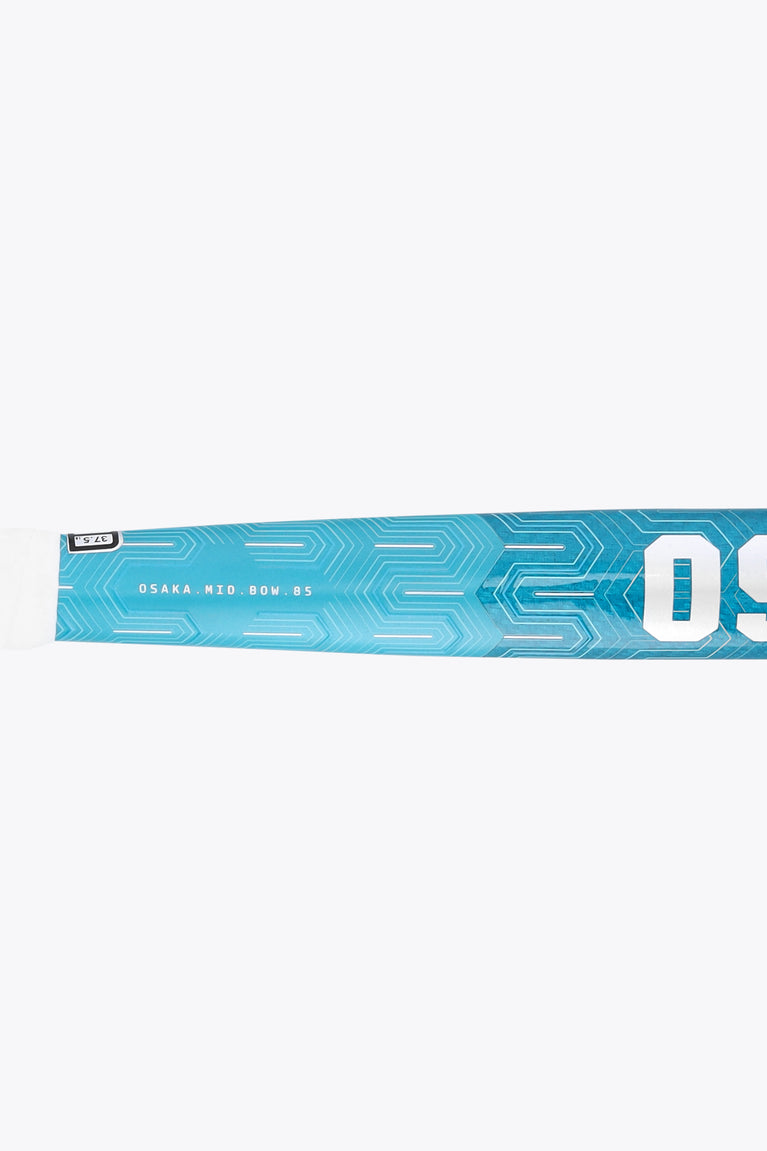 Close-up of blue field hockey stick blade with printed text and geometric pattern