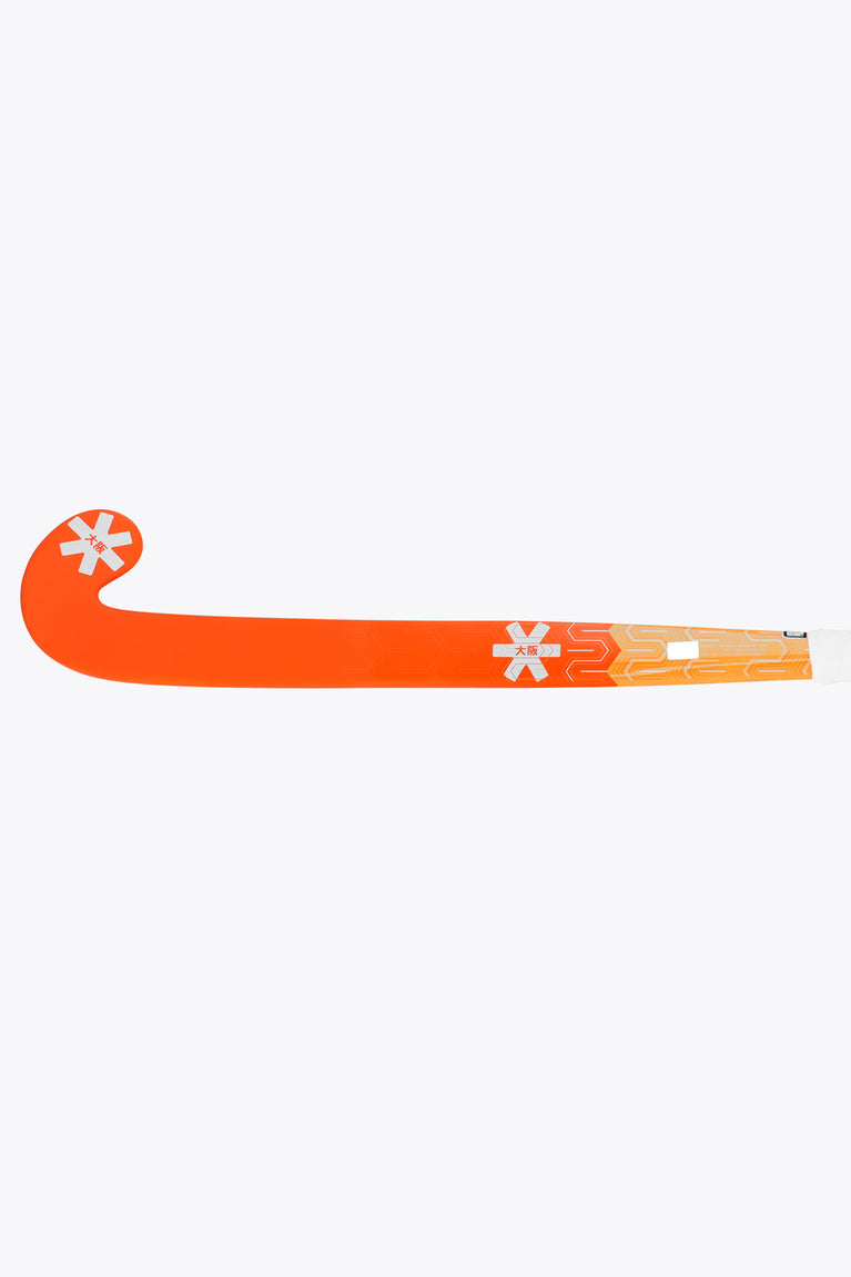 Orange field hockey stick with long shaft and patterned graphics along the blade