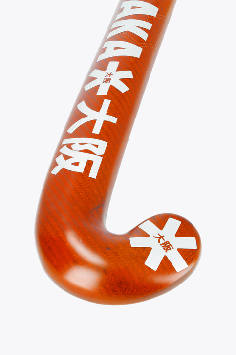 Bright orange field hockey stick with white shaft and curved U-shaped head