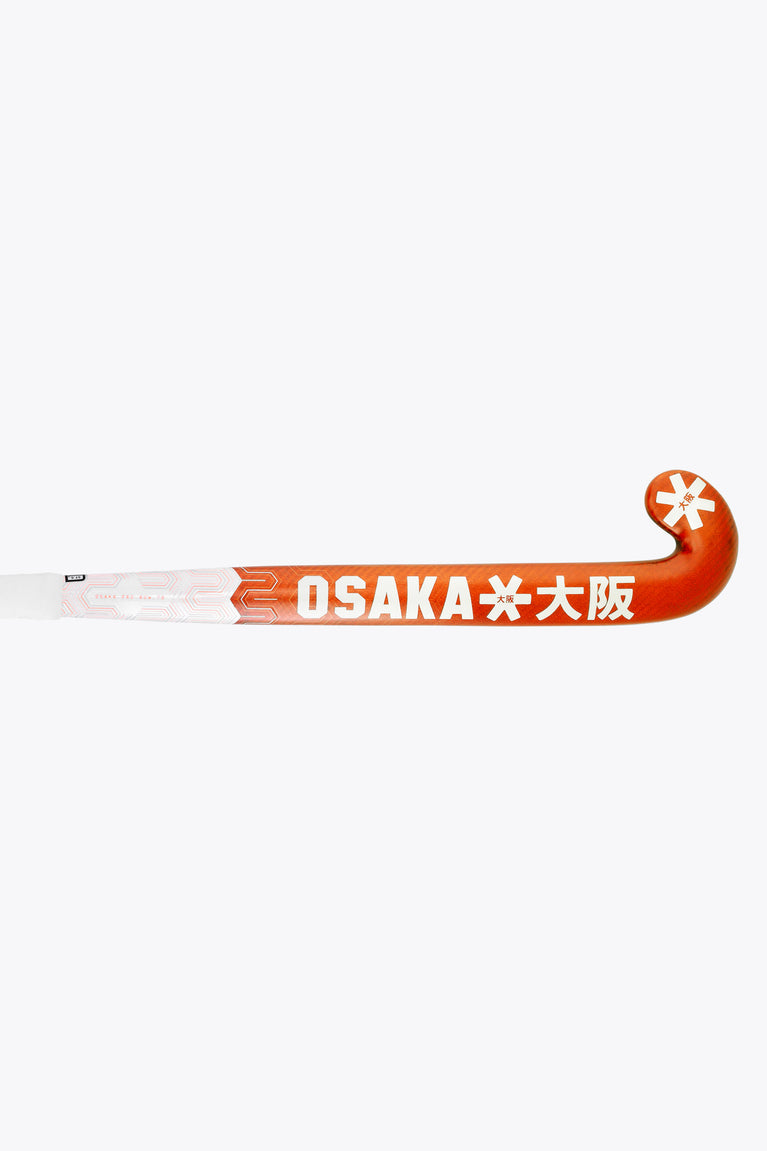 Field hockey stick with OS logo and bright orange grip on white shaft