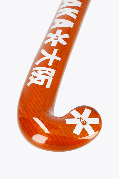 Bright orange field hockey stick with curved hook end and white accents