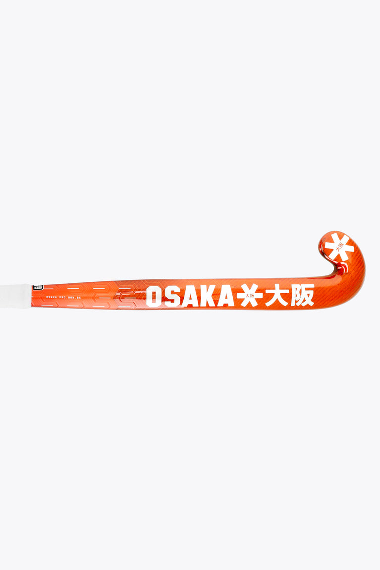 Bright orange field hockey stick blade showing OSAKA text and star logo