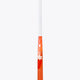 Bright orange field hockey stick curved end with white shaft