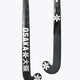 Dark field hockey stick with curved blade and star-style logos on the lower shaft
