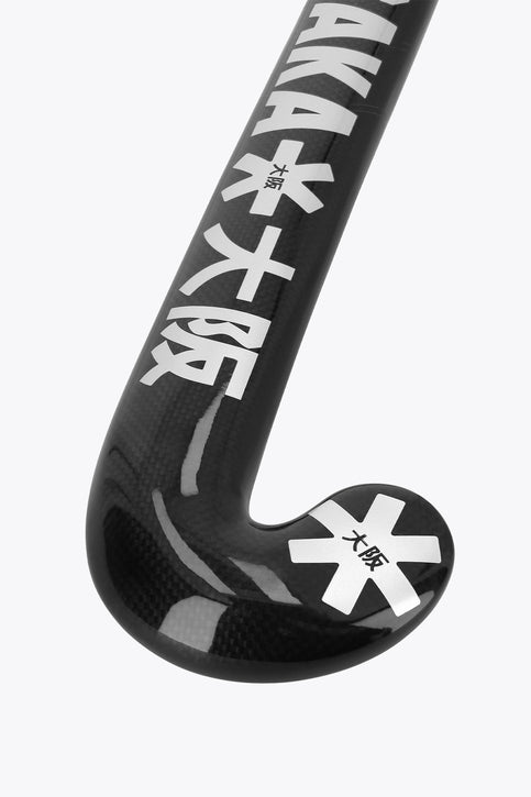 Dark field hockey stick with curved blade and star-style logos on the lower shaft