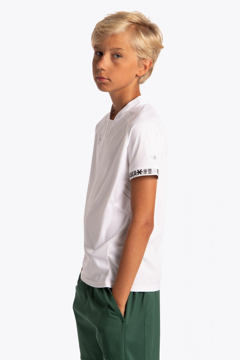 Boy wearing the Osaka Kids Jersey in white. Side view
