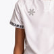 Boy wearing the Osaka Kids Jersey in white. Front detail logo view