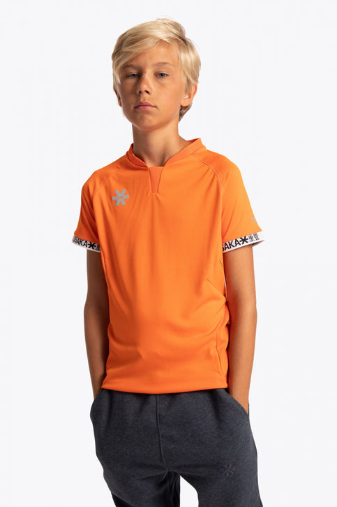Boy wearing the Osaka Kids Jersey in Orange. Front view