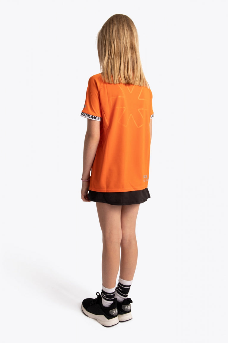 Girl wearing the Osaka Kids Jersey in Orange. Back view