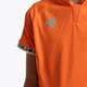 Boy wearing the Osaka Kids Jersey in Orange. Front detail logo view