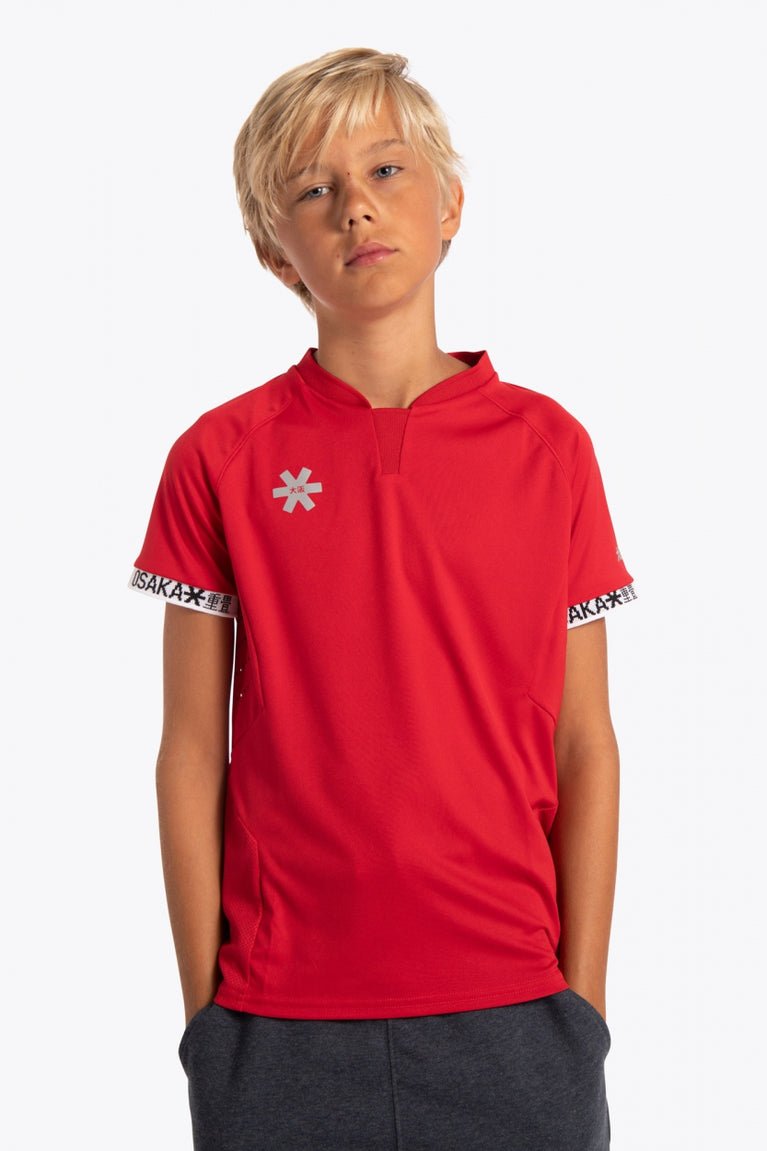 Boy wearing the Osaka Kids Jersey in Red. Front view