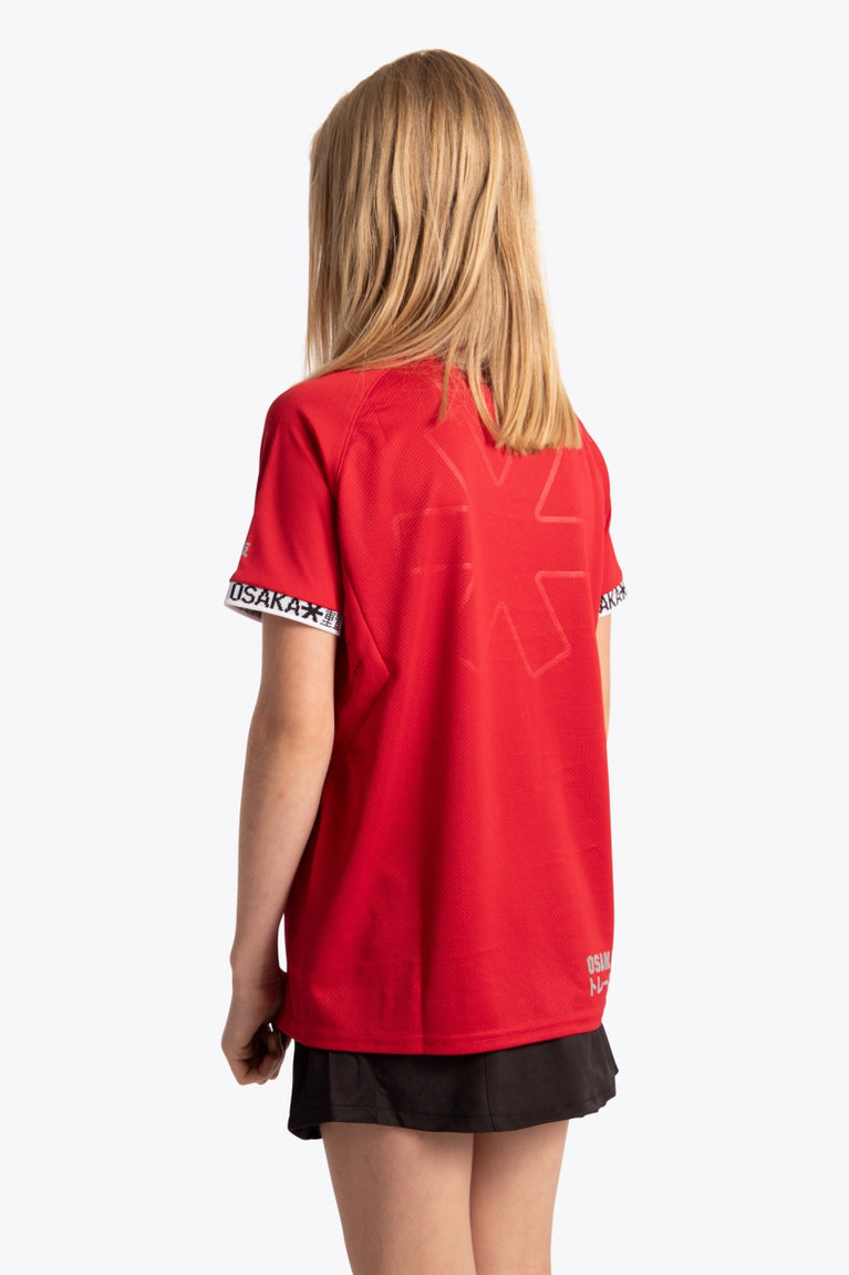 Girl wearing the Osaka Kids Jersey in Red. Back view