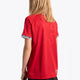 Girl wearing the Osaka Kids Jersey in Red. Back view