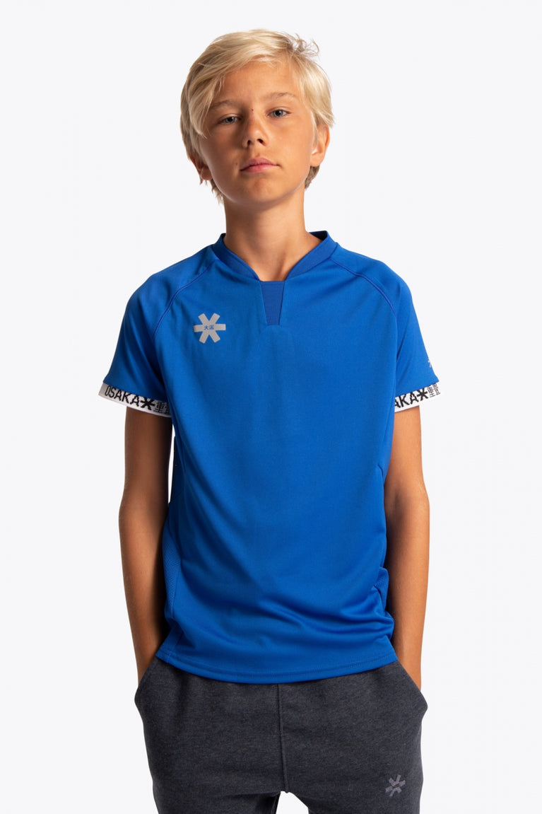 Boy wearing the Osaka Kids Jersey in Royal blue. Front view