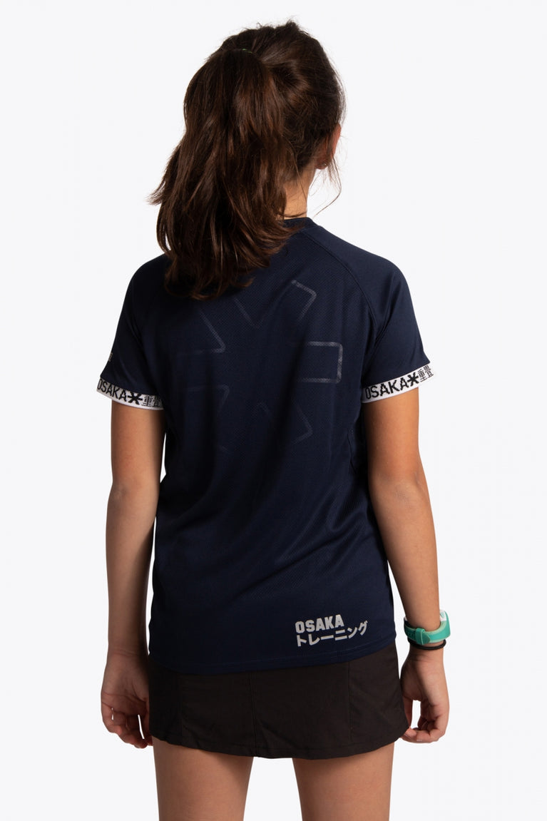 Girl wearing the Osaka Kids Jersey in Navy. Back view