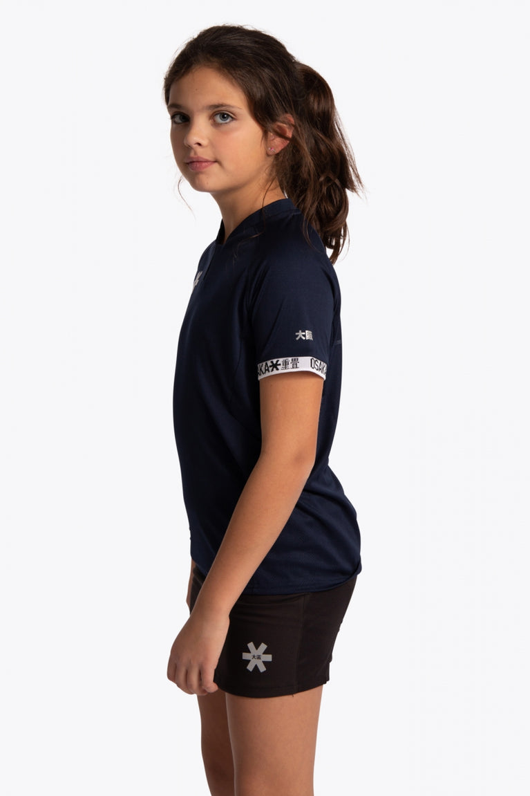 Girl wearing the Osaka Kids Jersey in Navy. Side view