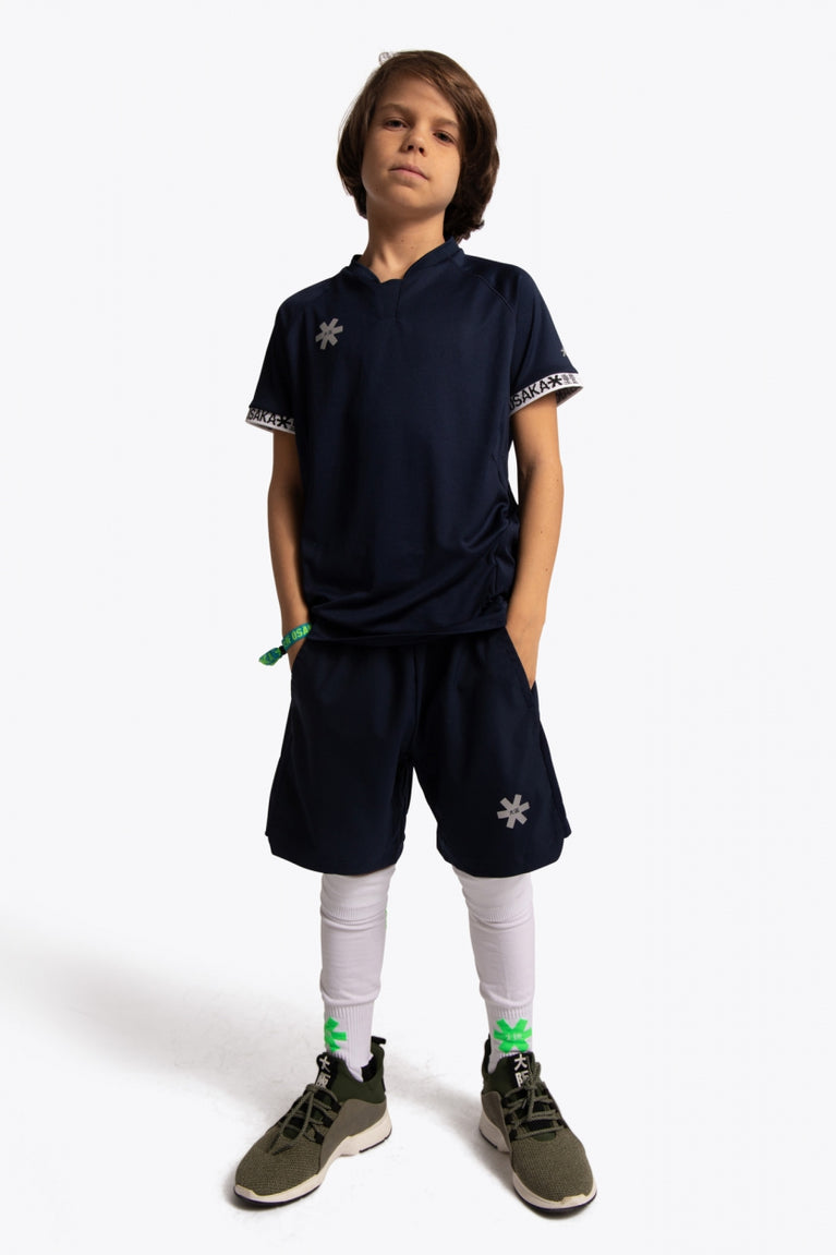 Boy wearing the Osaka Kids Jersey in Navy. Front view