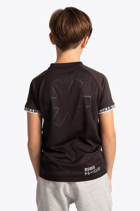Boy wearing the Osaka Kids Jersey in Black. Front view
