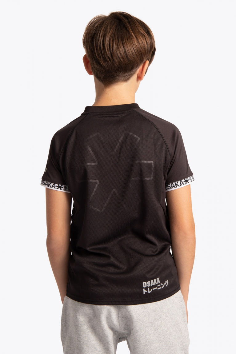 Boy wearing the Osaka Kids Jersey in Black. Back view