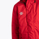 Boy wearing the Osaka Kids Stadium Jacket in Red. Front detail logo view