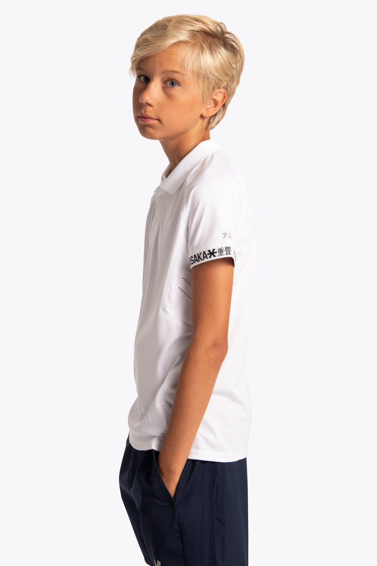 Boy wearing the Osaka Kids Polo Jersey in White. Side view