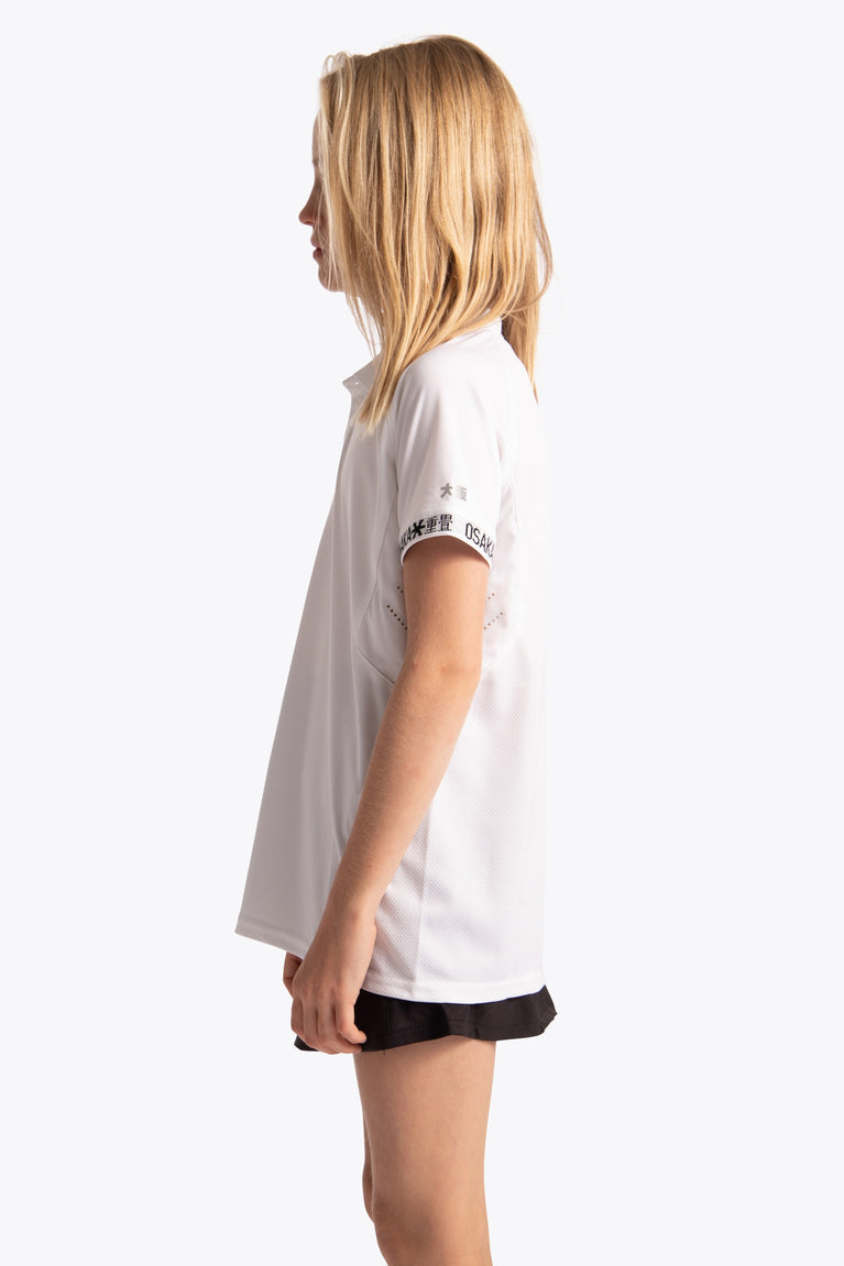 Girl wearing the Osaka Kids Polo Jersey in White. Side view
