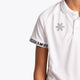 Boy wearing the Osaka Kids Polo Jersey in White. Front detail logo view