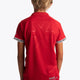 Boy wearing the Osaka Kids Polo Jersey in Red. Back view