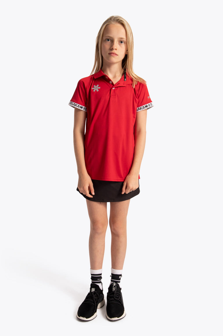 Girl wearing the Osaka Kids Polo Jersey in Red. Front view