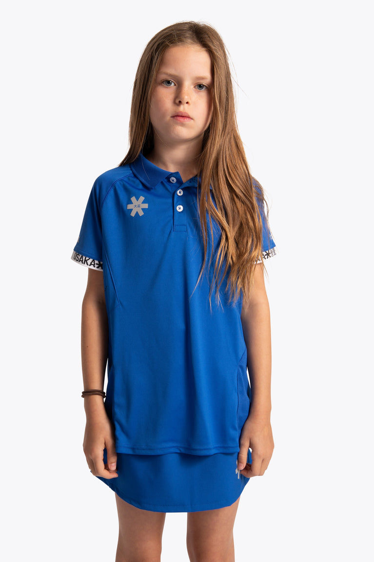 Girl wearing the Osaka Kids Polo Jersey in Royal blue. Front view