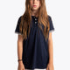 Girl wearing the Osaka Kids Polo Jersey in Navy. Front view