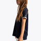 Girl wearing the Osaka Kids Polo Jersey in Navy. Side view