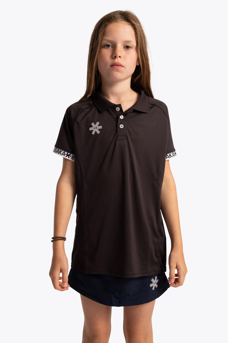 Girl wearing the Osaka Kids Polo Jersey in Black. Front view