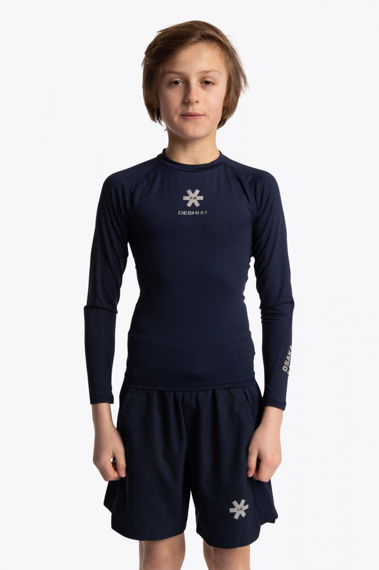 Boy wearing the Osaka Kids Baselayer Top in Navy. Front view