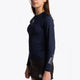 Girl wearing the Osaka Kids Baselayer Top in Navy. Side view