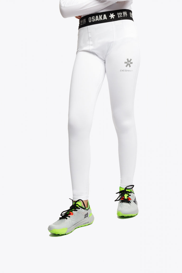 Model wearing the Osaka Kids Baselayer Tights in White. Front view