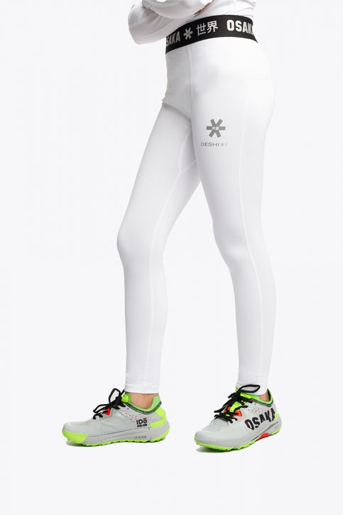 Model wearing the Osaka Kids Baselayer Tights in White. Front view