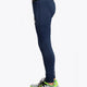 Model wearing the Osaka Kids Baselayer Tights in Navy. Side view