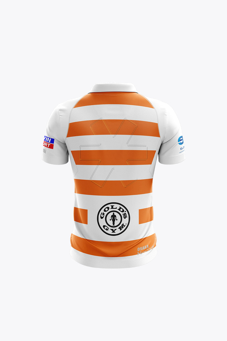 Kids white polo jersey back with orange striped bands and central circular badge.