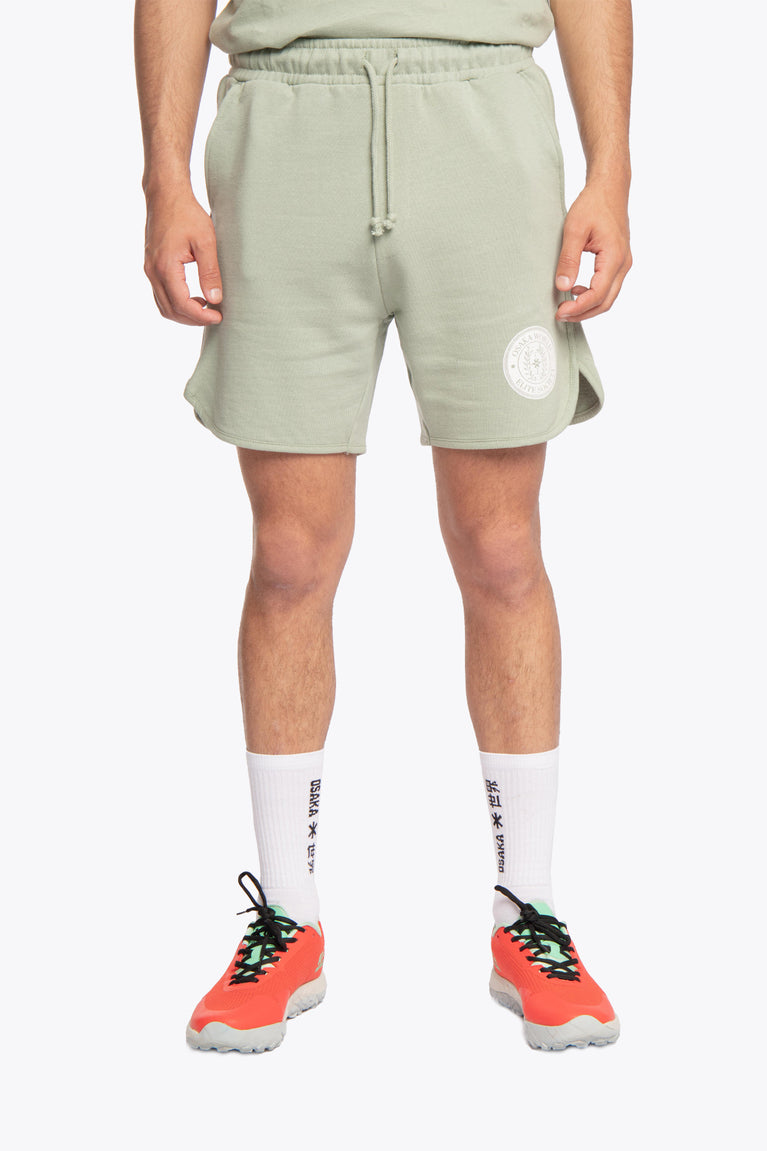 Iceberg green colour Osaka men shorts Elite Society from The Sports Society Collection made for a retro country vintage sport-chic aesthetics. 90s era ode style for that on-and off-field lifestyle. Photo of model waist and down front view
