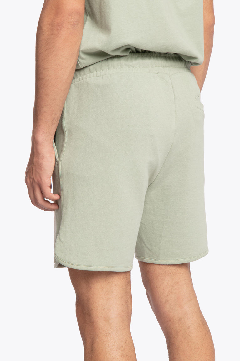 Iceberg green colour Osaka men shorts Elite Society from The Sports Society Collection made for a retro country vintage sport-chic aesthetics. 90s era ode style for that on-and off-field lifestyle. Shorts left-back photo close view of model